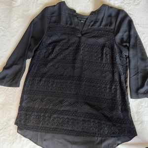 Black, intricately detailed blouse.